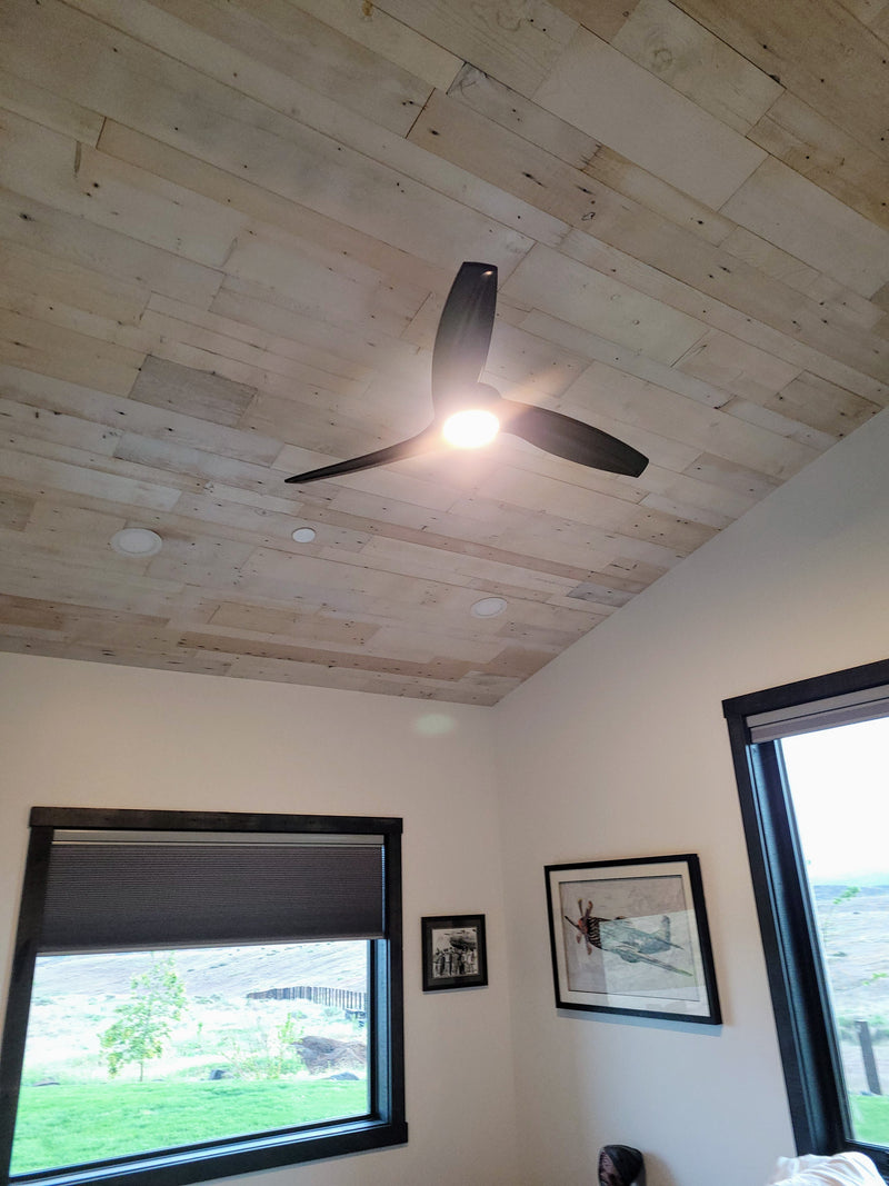 This ceiling features pre-finished white-washed pine paneling installed over a substrate.