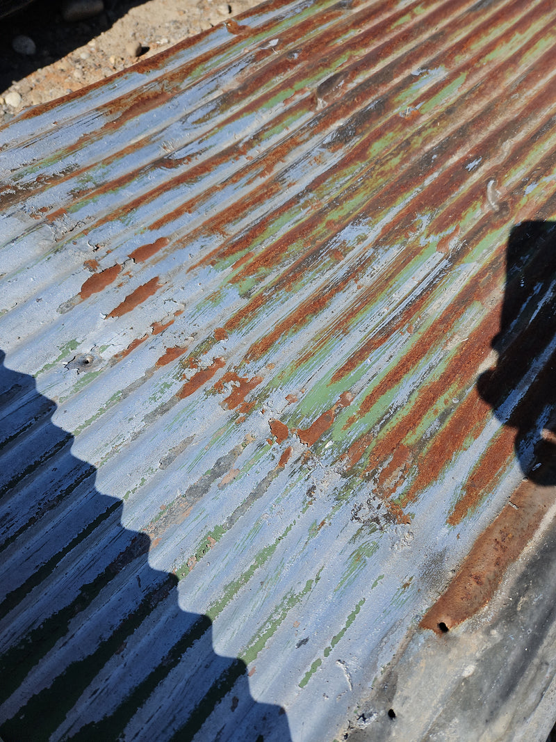 Small corrugated old roofing tin with coatings & paint in variety of colors