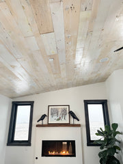 bedroom ceiling and fireplace feature reclaimed paneling