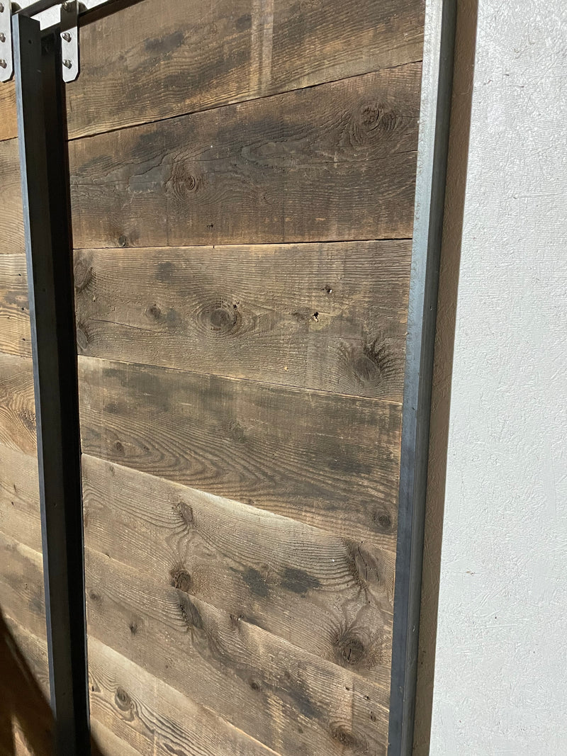 Rough barnwood horizontal plank door with steel frame