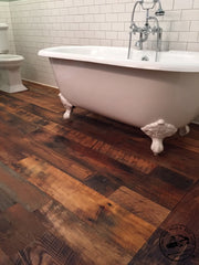 clawfoot tub over engineered reclaimed flooring in bath